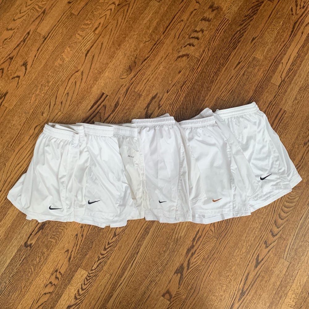 6 pairs of white Nike athletic shorts
